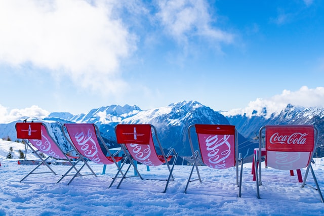 5 deckchairs on top of a snowy mountain