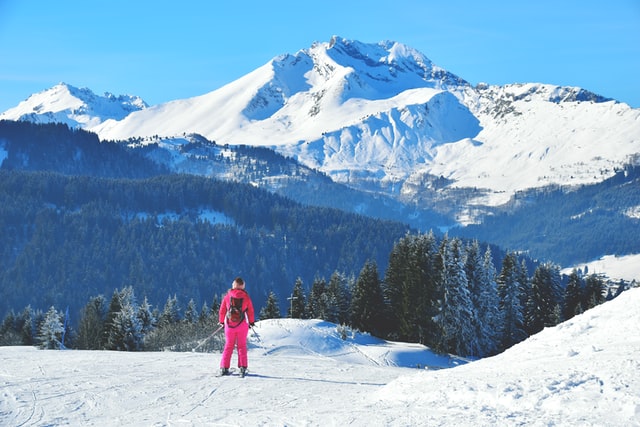 Skier dressed in pink skiing down a piste in Morzine