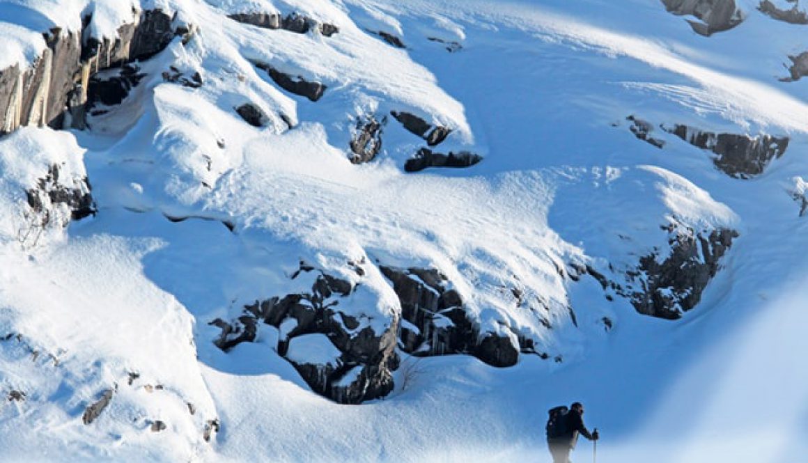 A solo man skier ski touring through the mountains in Chamonix