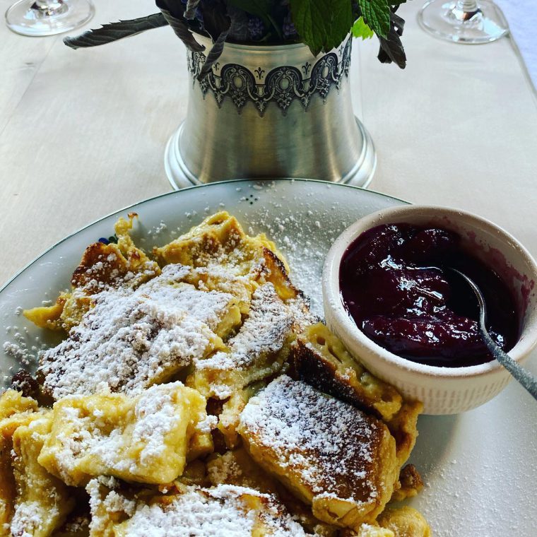 Plate of chopped up pancakes with jam on the side