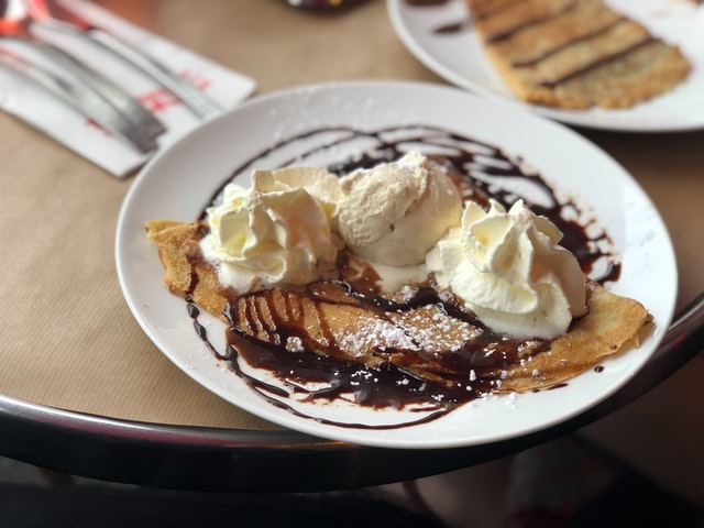 Think crepe covered in chocolate sauce, ice cream and cream.