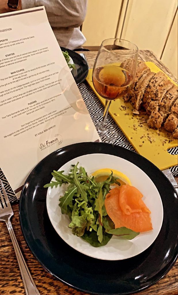 Plate of salmon and salad on a dining table