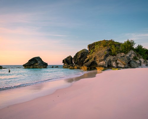 Sunrise over a pink sand beach in a tropical destination