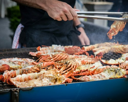 Man grilling crabs on a BBQ