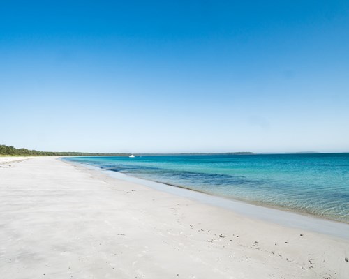 Wide stretch of untouched white sand beach and calm turquoise sea