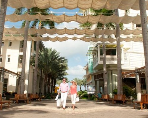 Man and women shopping and walking between Caribbean buildings - Camana, Cayman islands