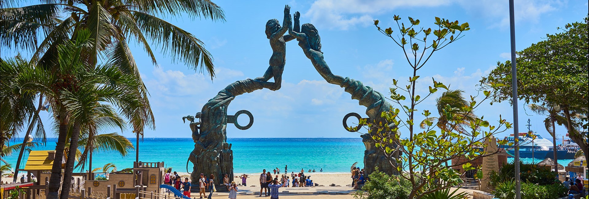 Tall mermaid statue at a public beach in Mexico