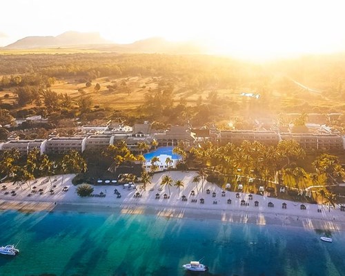 Landscape photo of sun setting on a luxury beach resort 