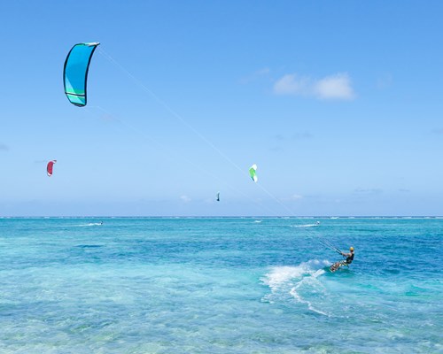 Kite surfer on clear blue tropical water