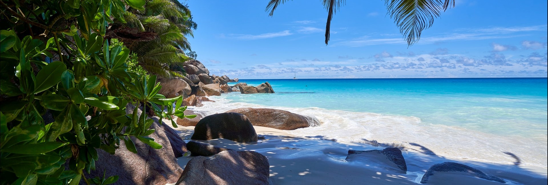 Large rocks on a tropical white sand beach 
