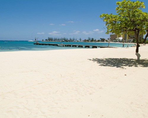 A wide, white sand beach in a Caribbean destination