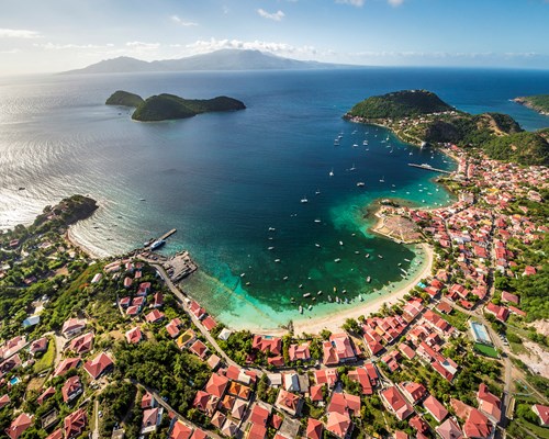 Aerial view of Les Saintes town, white sand coastline and small surrounding islands