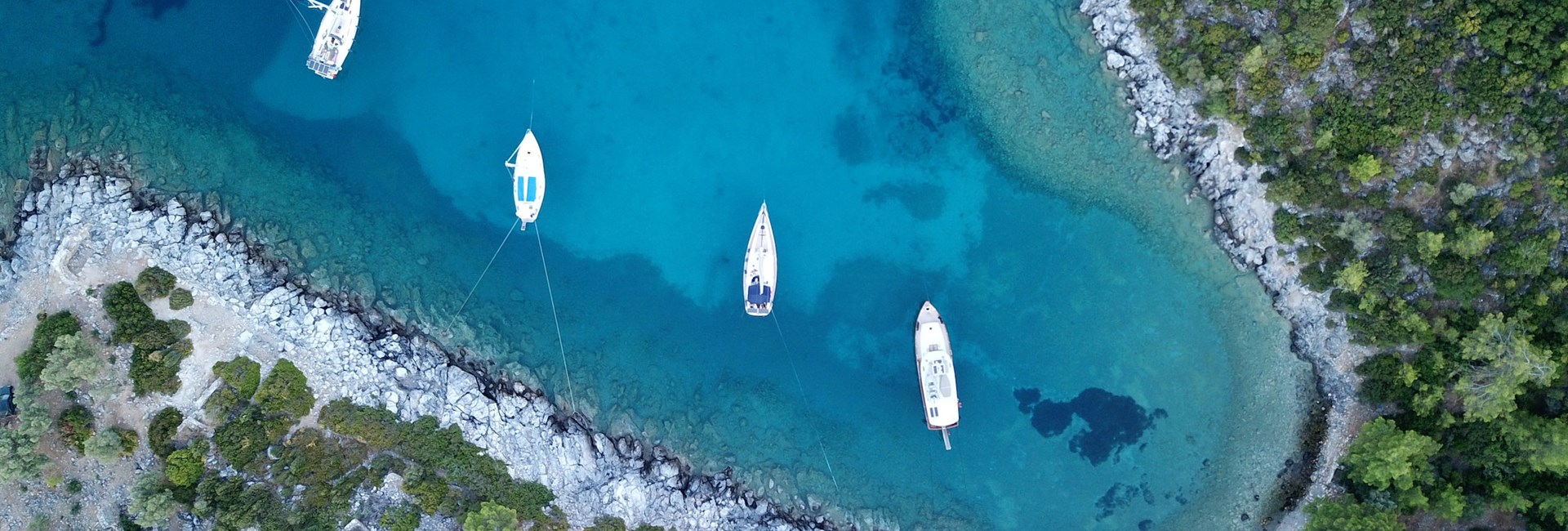 white boats on blue water surrounded by beach