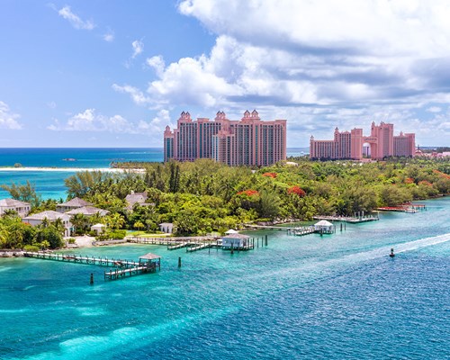 Large pink resort hotels on tropical island in Bahamas
