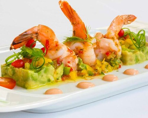 Prawns and fresh ingredients on a white plate 