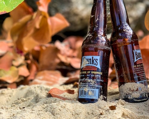 Close up of Banks beer bottles on a beach