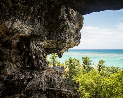 Cave exit with an landscape view of turquoise seaside