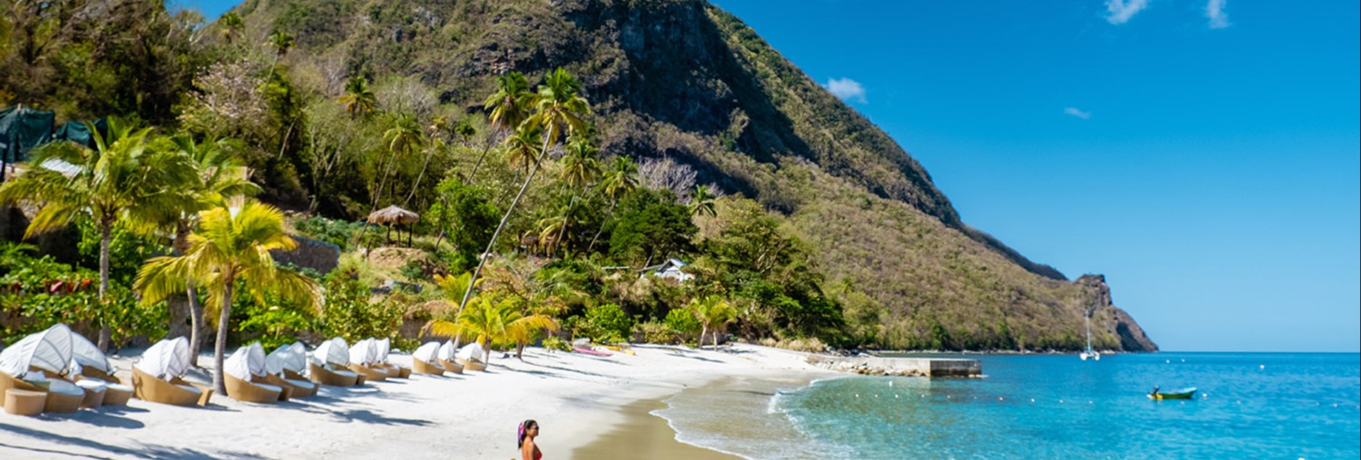 Woman walking on the beach with red dress in St Lucia 