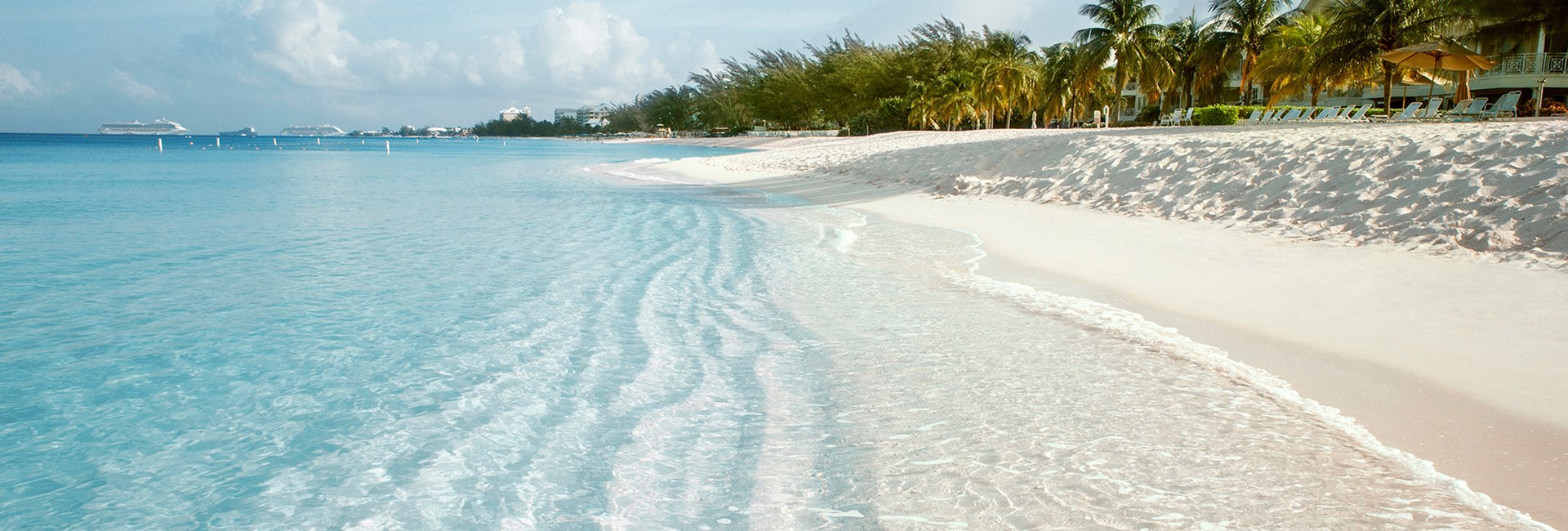A stretch of white sand tropical beach with clear calm sea - Seven Mile Beach
