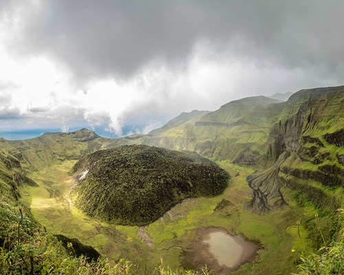 La Soufriere volcano crater panorama with tuff cone hidden in green
