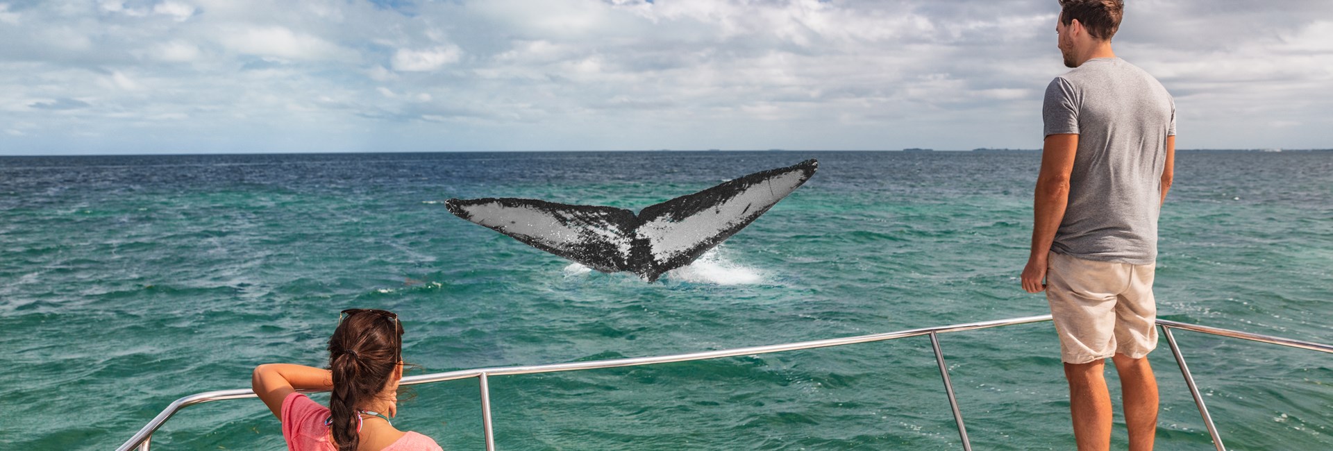 Couple on a boat watching humpback whales in the Dominican Republic