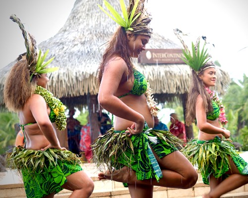 Four women hula dancers in traditional costumes