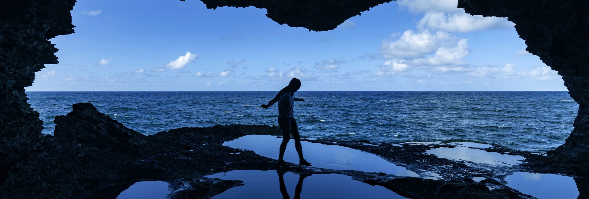 Woman standing in Animal Flower Cave at North Point in Barbados
