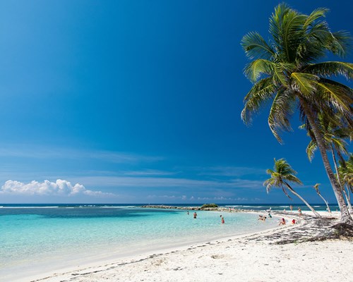 Pristine white sand beach in a sunny tropical destination 