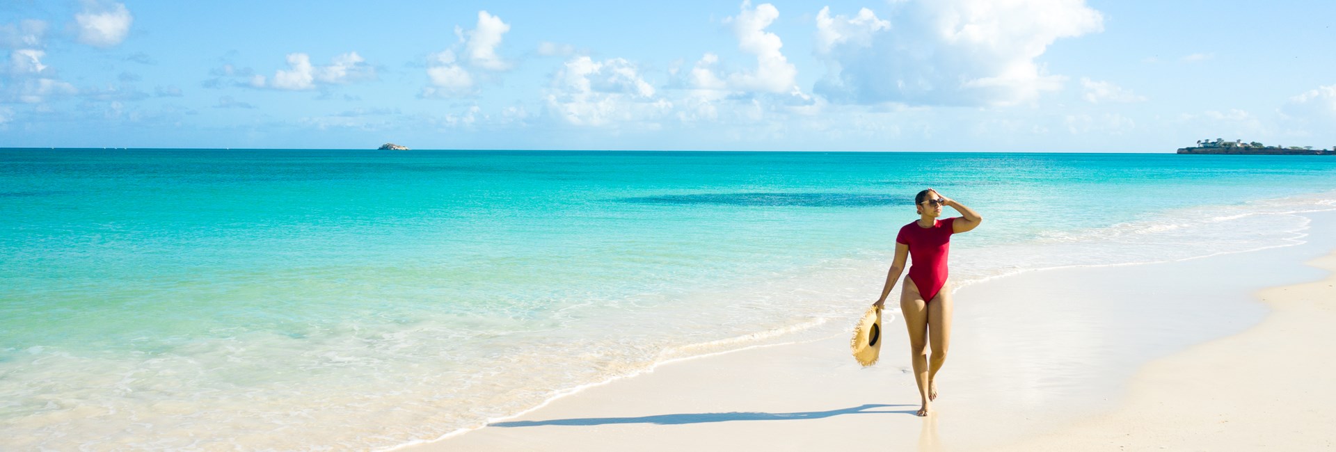 woman walking along paradise caribbean beach