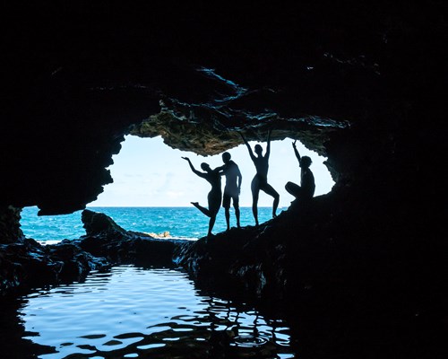 Friends posing at entrance of Animal Flower Cave in Barbados