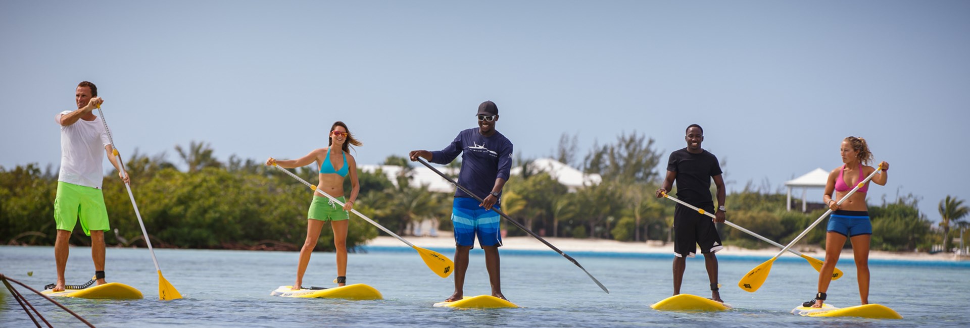 group of friends on stand up paddle boards