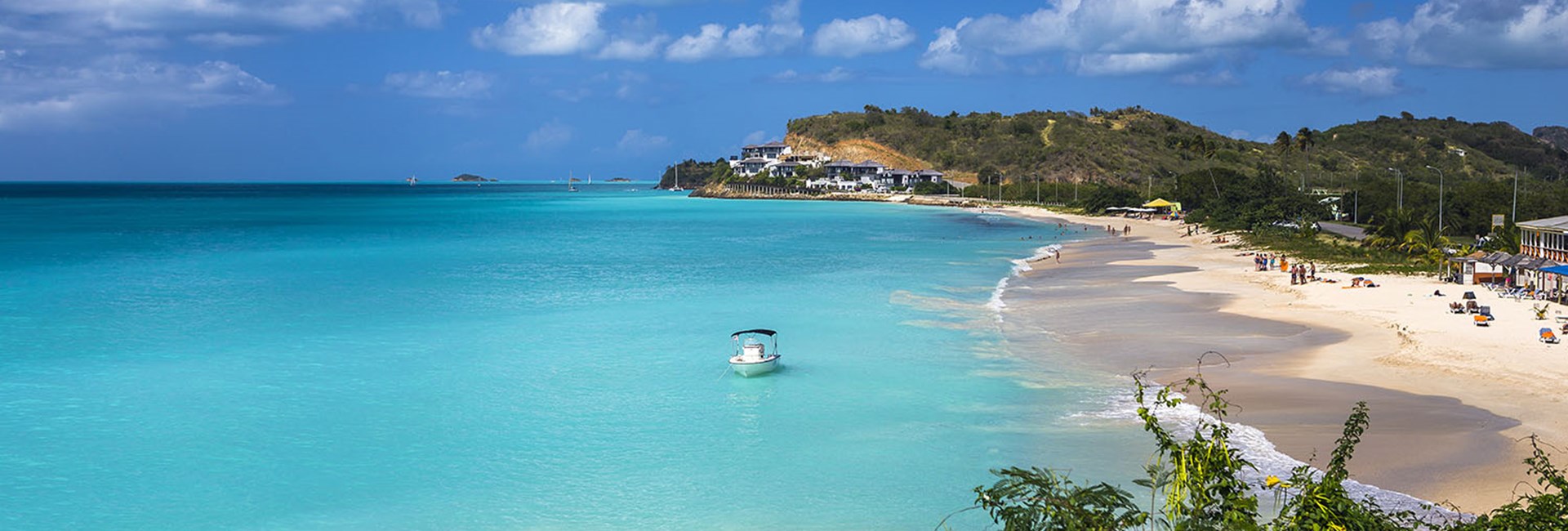 Tropical beach at Antigua with white sand, turquoise sea and blue sky