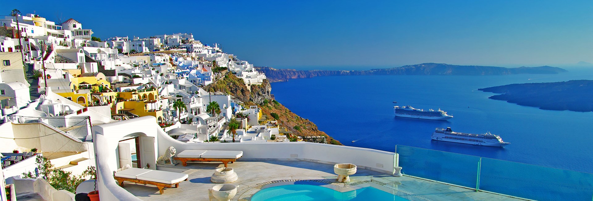 Top european holiday destination with accommodation, pool, blue sea and cobalt sky.