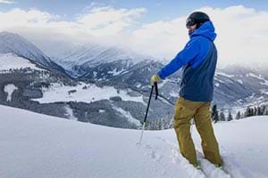 Male skier standing at the top of a mountain
