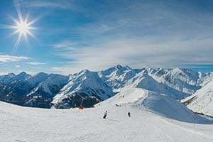 Sun shining at the top of a mountain